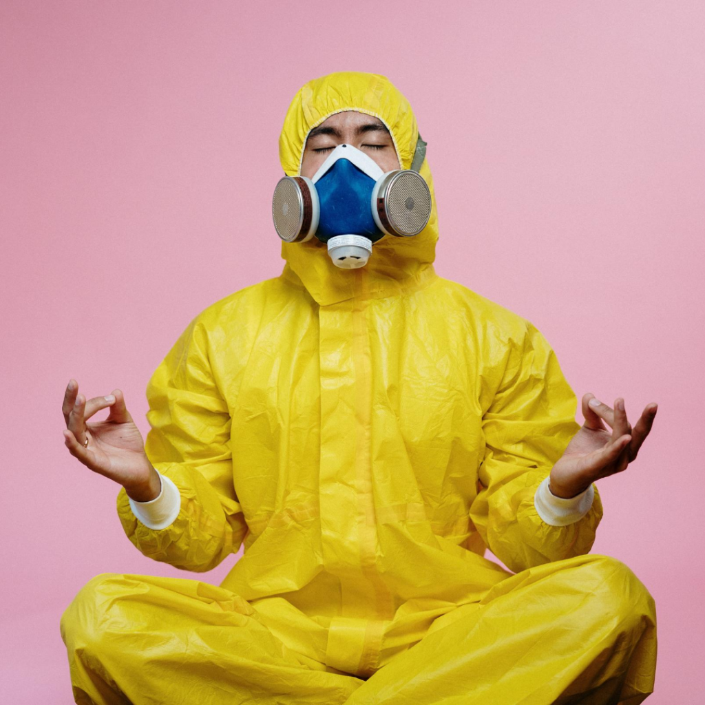 A man in a yoga pose wearing a hazchem suit as a metaphor for boosting your immune system