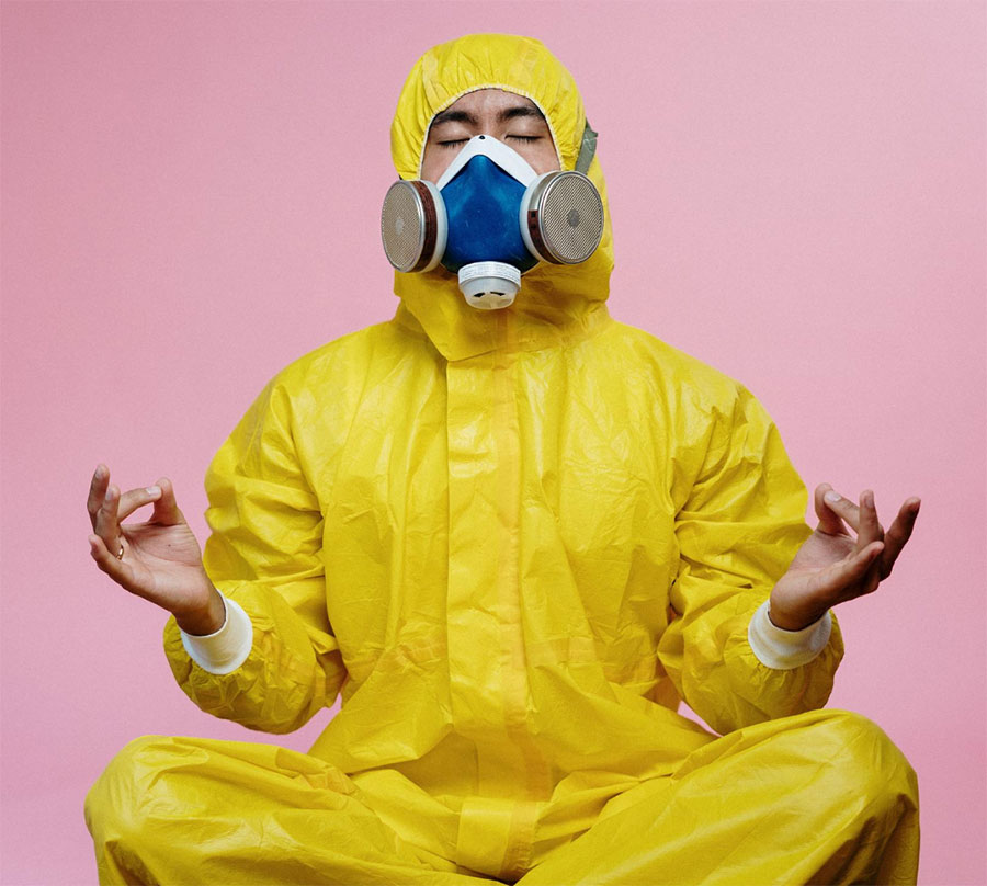 A man in a yoga pose wearing a hazchem suit as a metaphor for boosting your immune system